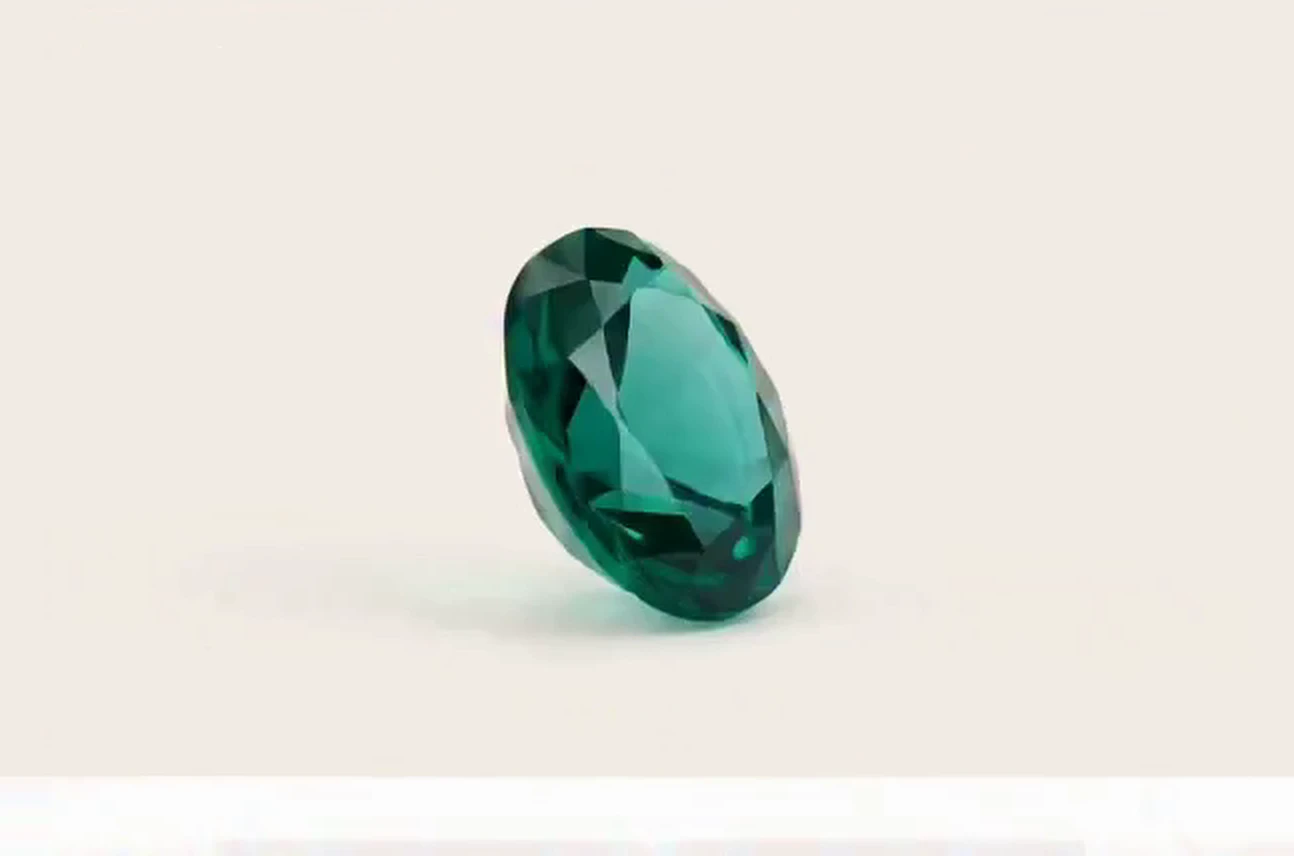 Oval emerald pendant on a gold chain